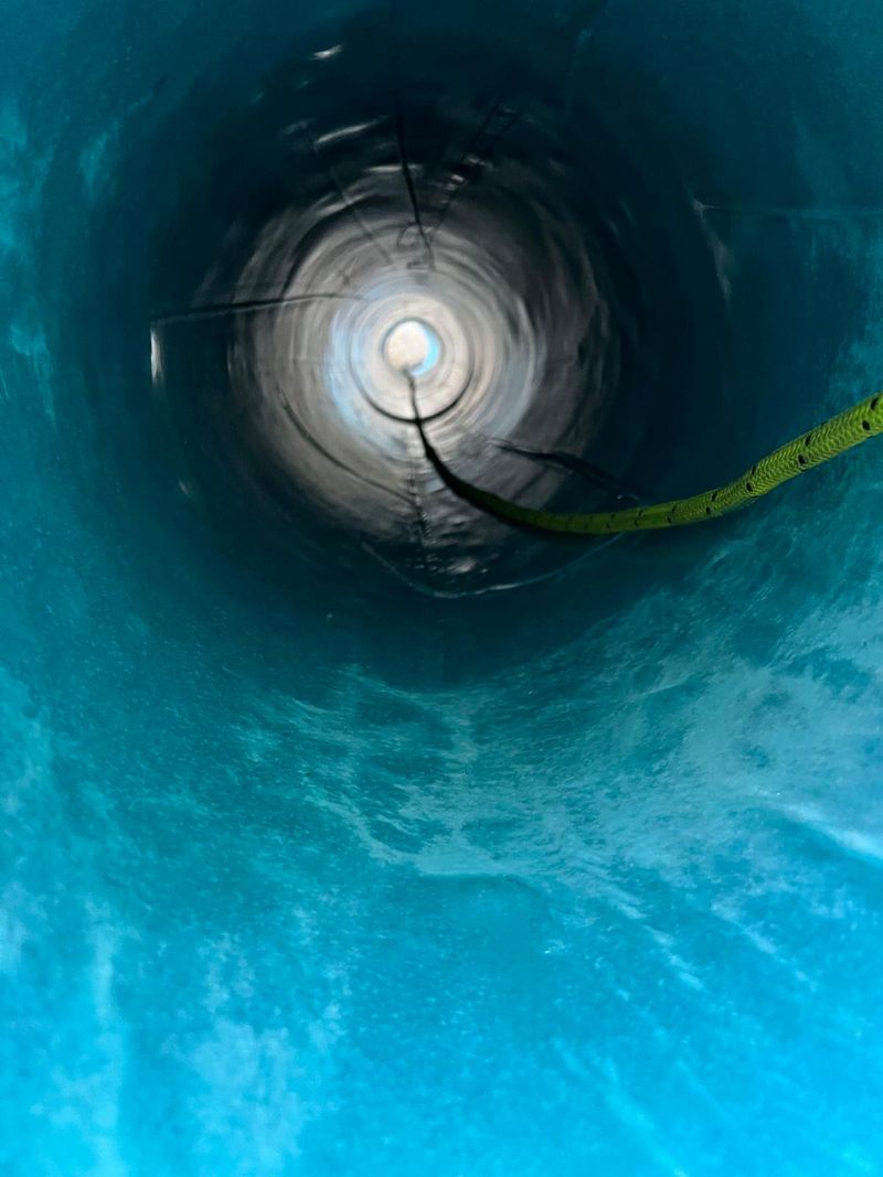 Trenchless pipe rehabilitation — inside relined pipe showing blue protective lining