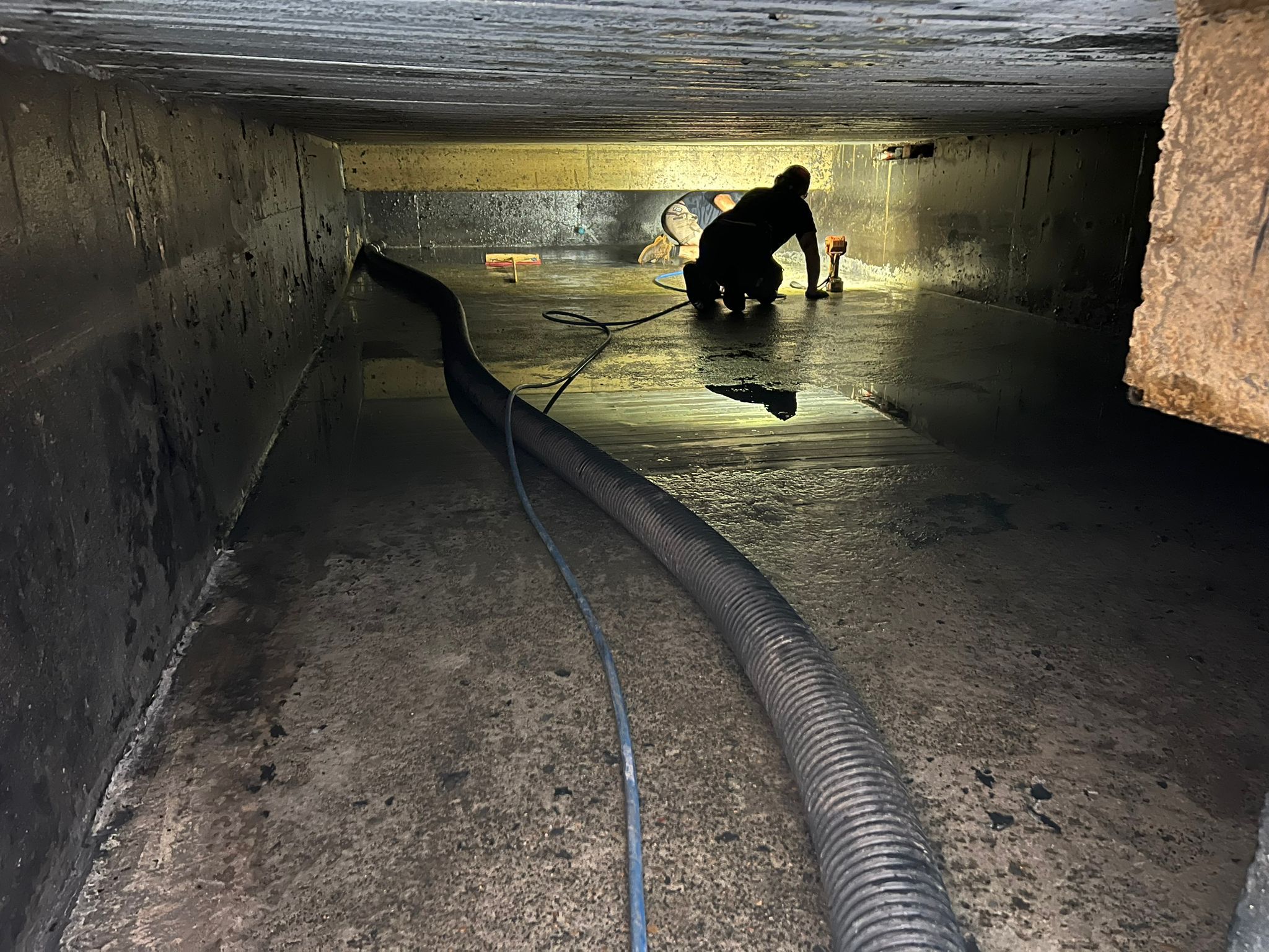 Transport infrastructure rehabilitation — worker inside confined stormwater culvert