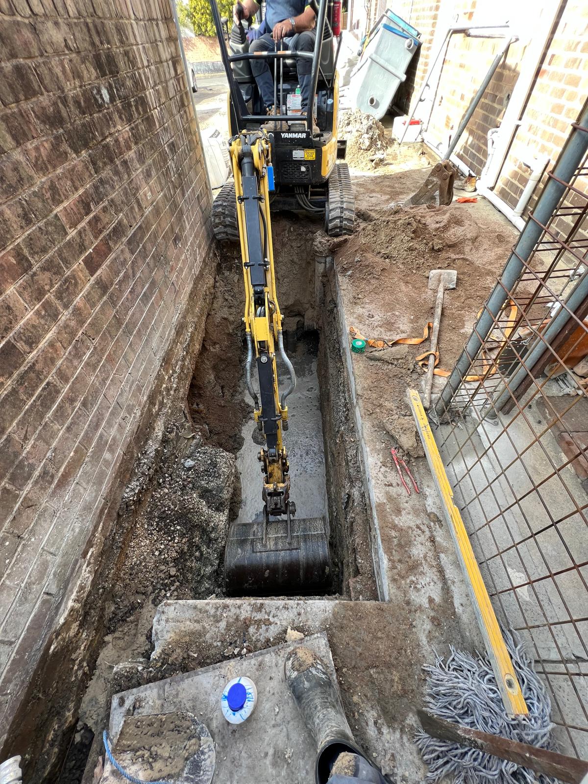 Excavation for conventional grease trap replacement on a commercial site